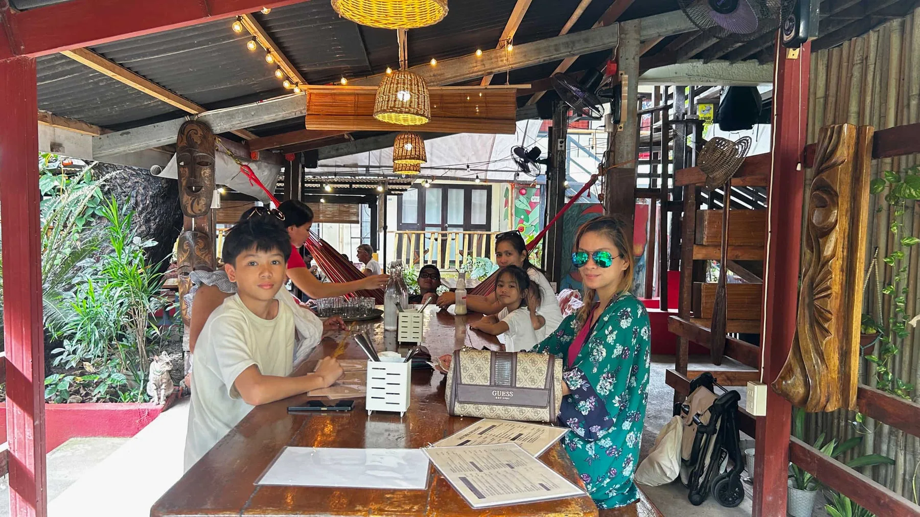 Guests at the counter of Whiskey's Café under the string lights