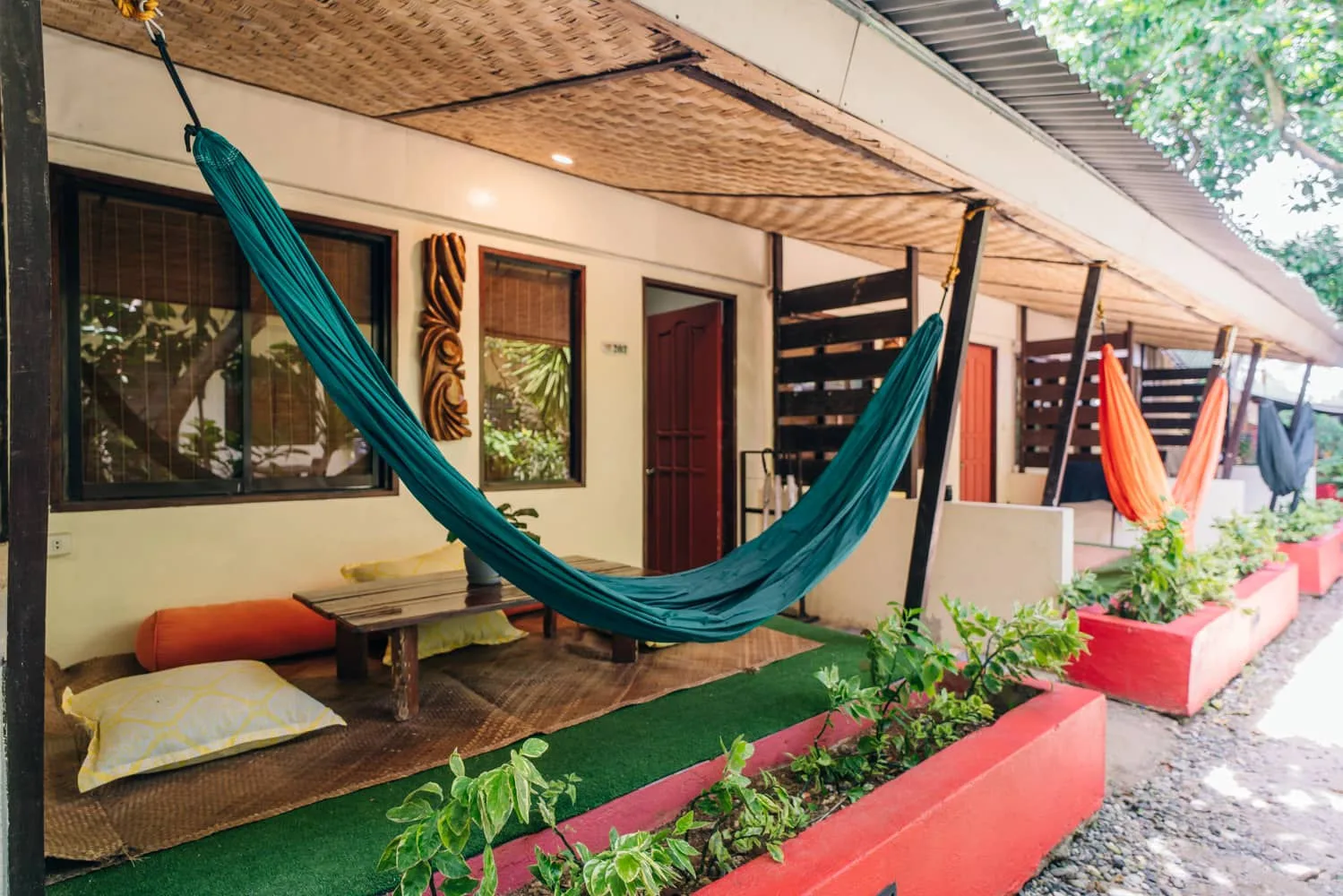 Hammocks strung across the shaded terraces at The Lazy Dog, Bulabog Beach